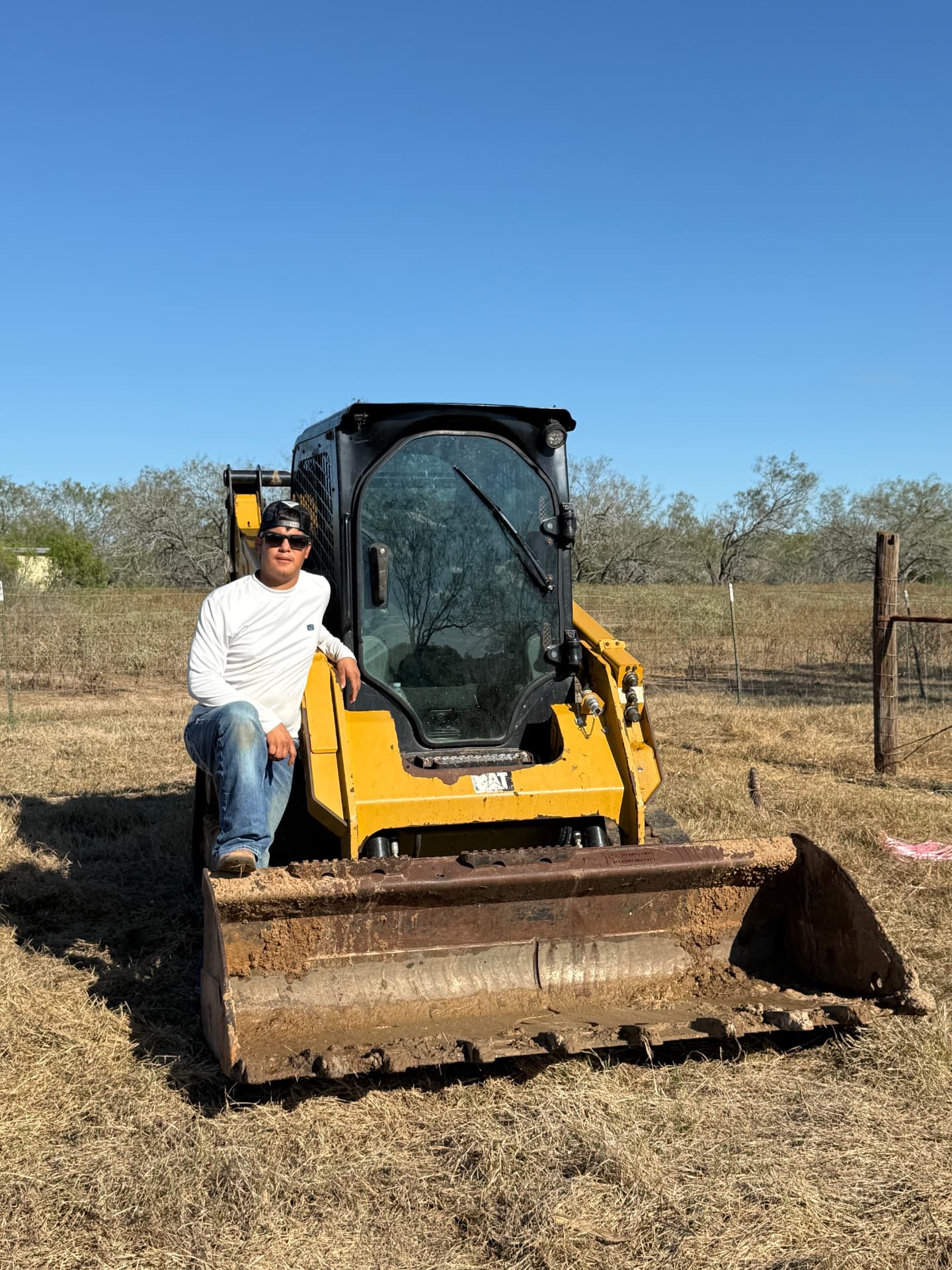 Fabian Martinez, owner of Martinez Ranch & Land Services, with his skid steer
